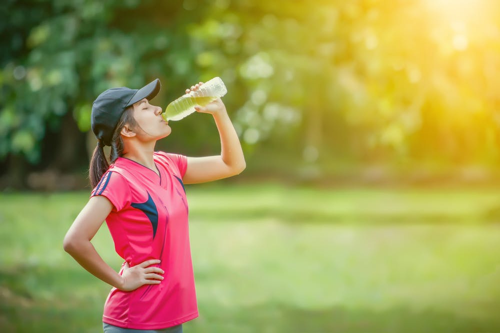 Lady drinking electrolyte drink